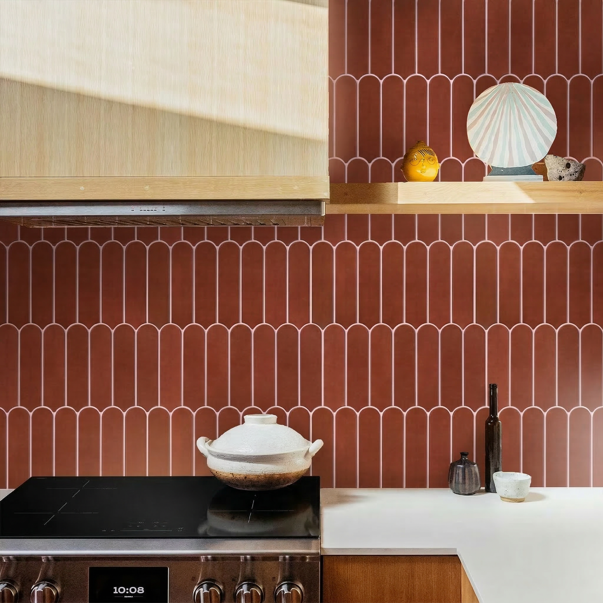 Kitchen with red patterned tiles, wooden cabinets, and a stove.