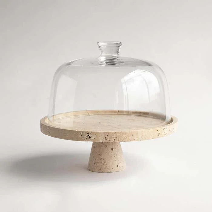 Glass cake stand with a terracotta base on a white background