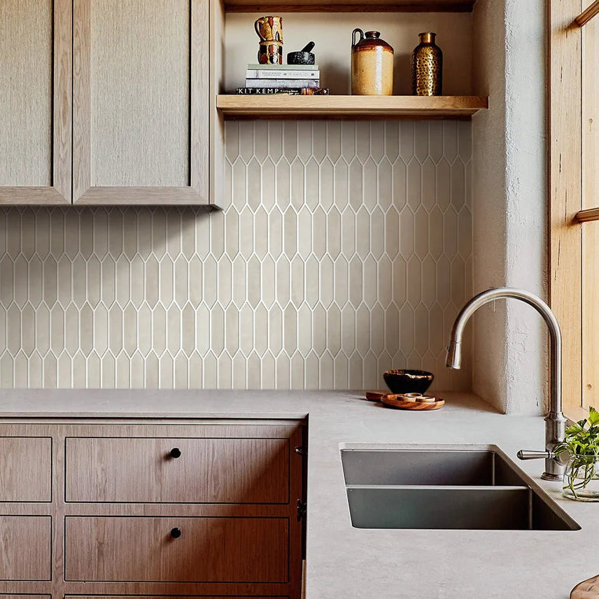 Modern kitchen with wooden cabinets, a sink, and decorative elements.